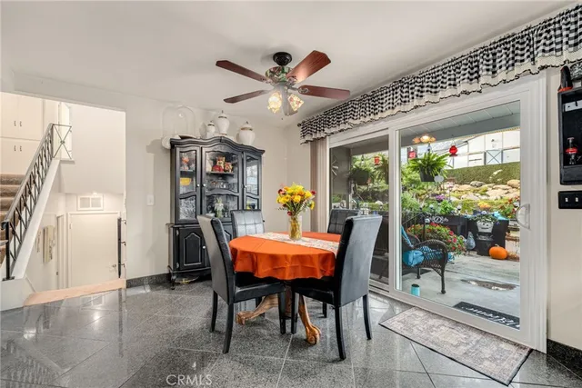 a dining room with furniture potted plants and wooden floor