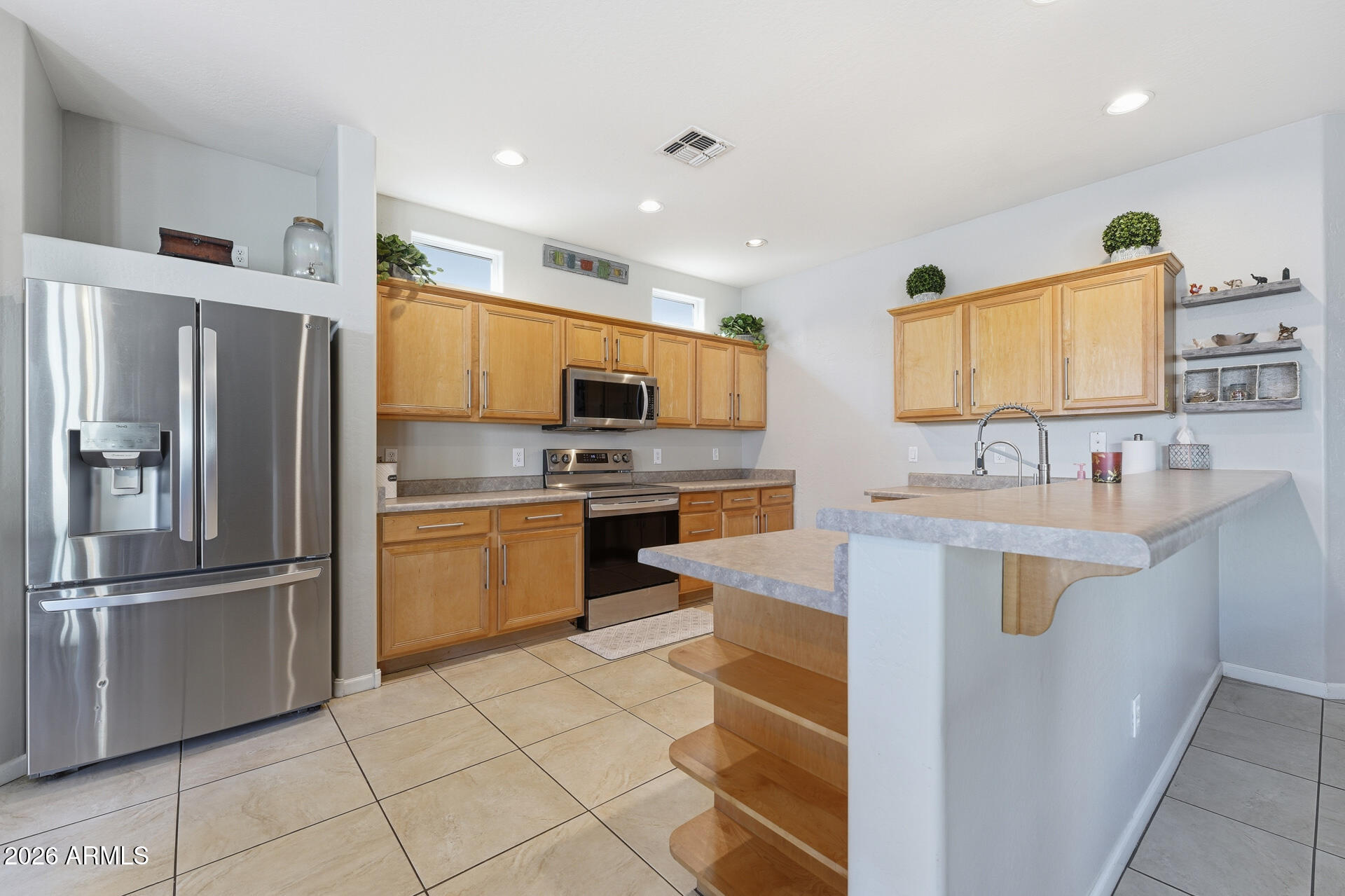 3273 East Fairview Street Gilbert, AZ 85295 - Photo 14 of 37 a kitchen with stainless steel appliances granite countertop a sink stove and refrigerator