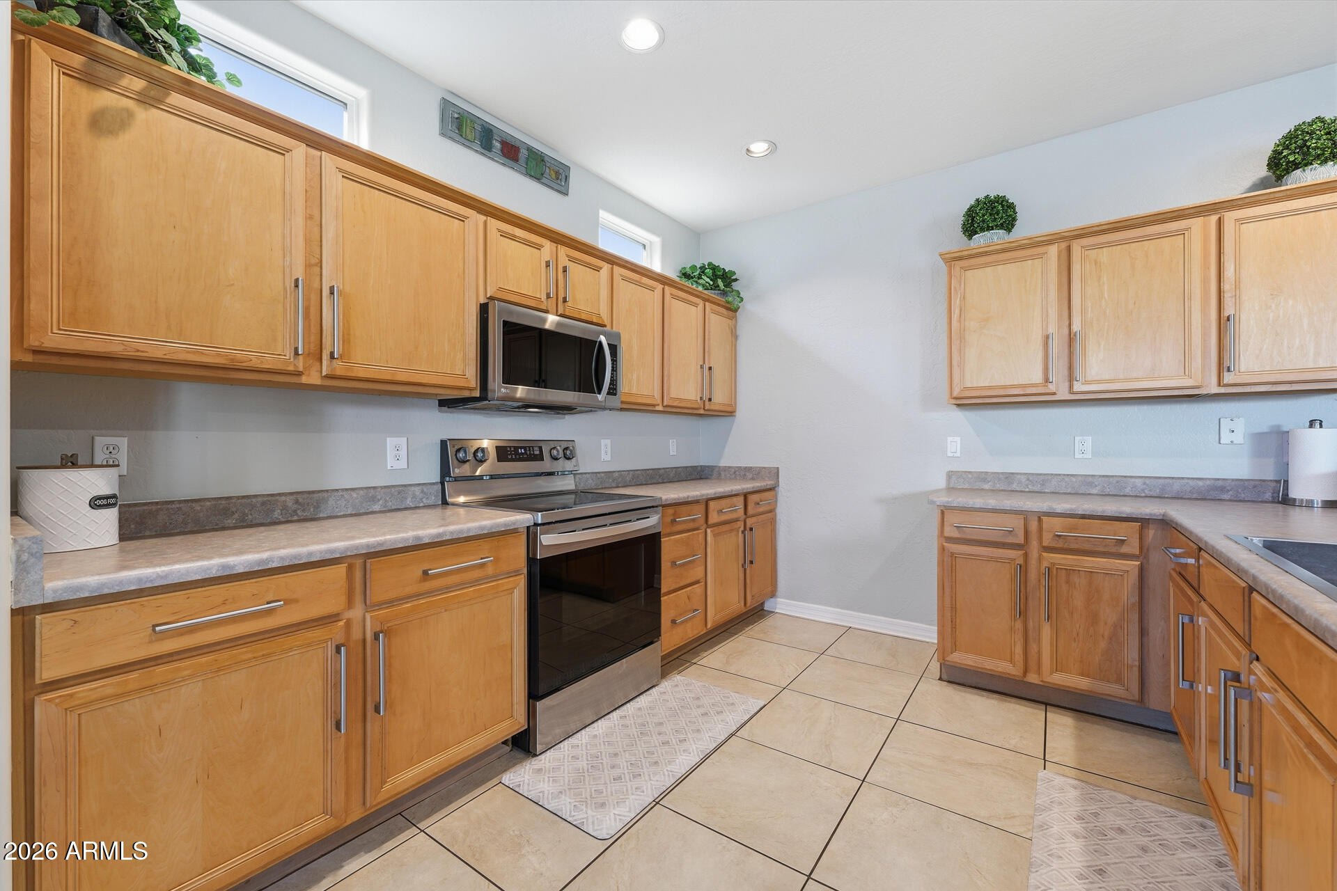 3273 East Fairview Street Gilbert, AZ 85295 - Photo 15 of 37 a kitchen with stainless steel appliances granite countertop a sink and cabinets