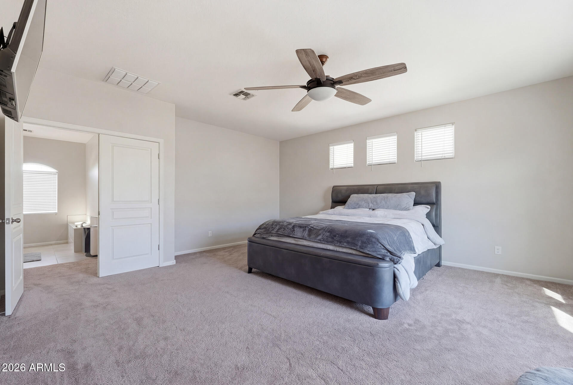 3273 East Fairview Street Gilbert, AZ 85295 - Photo 24 of 37 a spacious bedroom with a bed and a ceiling fan