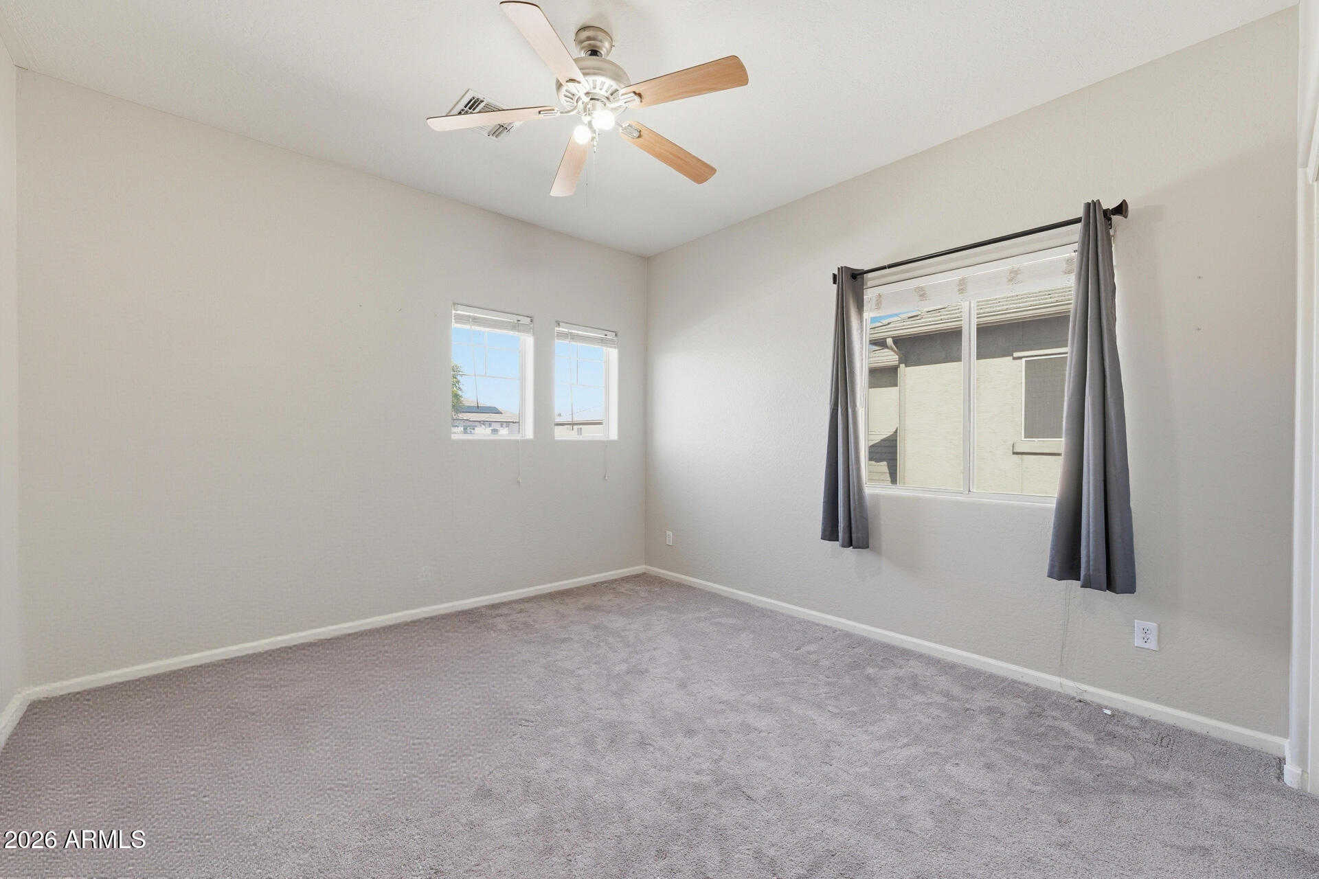 3273 East Fairview Street Gilbert, AZ 85295 - Photo 31 of 37 an empty room with a window and a fan