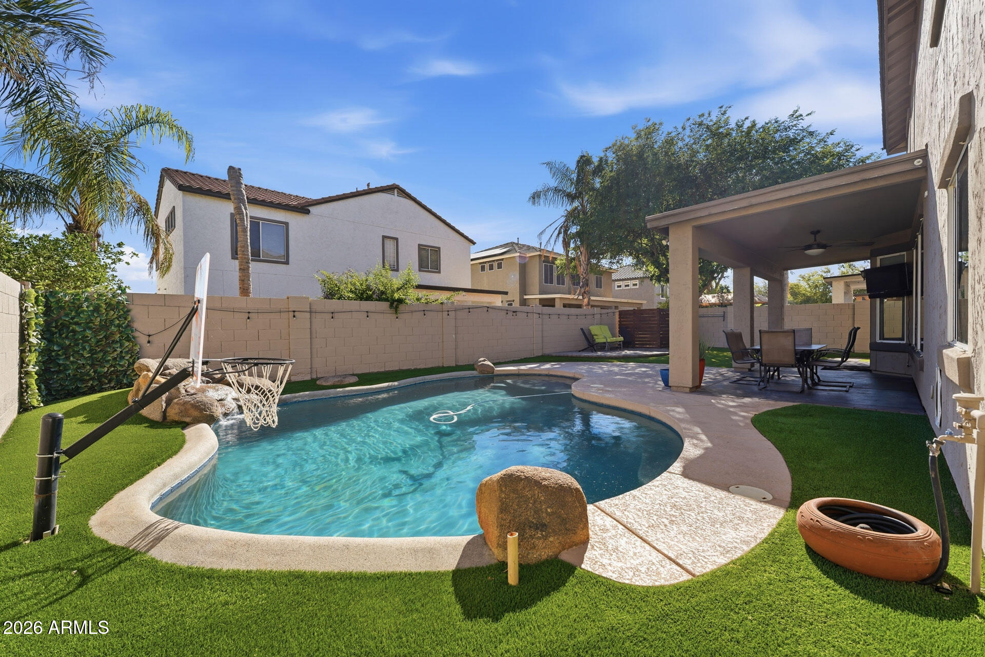3273 East Fairview Street Gilbert, AZ 85295 - Photo 35 of 37 a view of a house with backyard swimming pool and sitting area