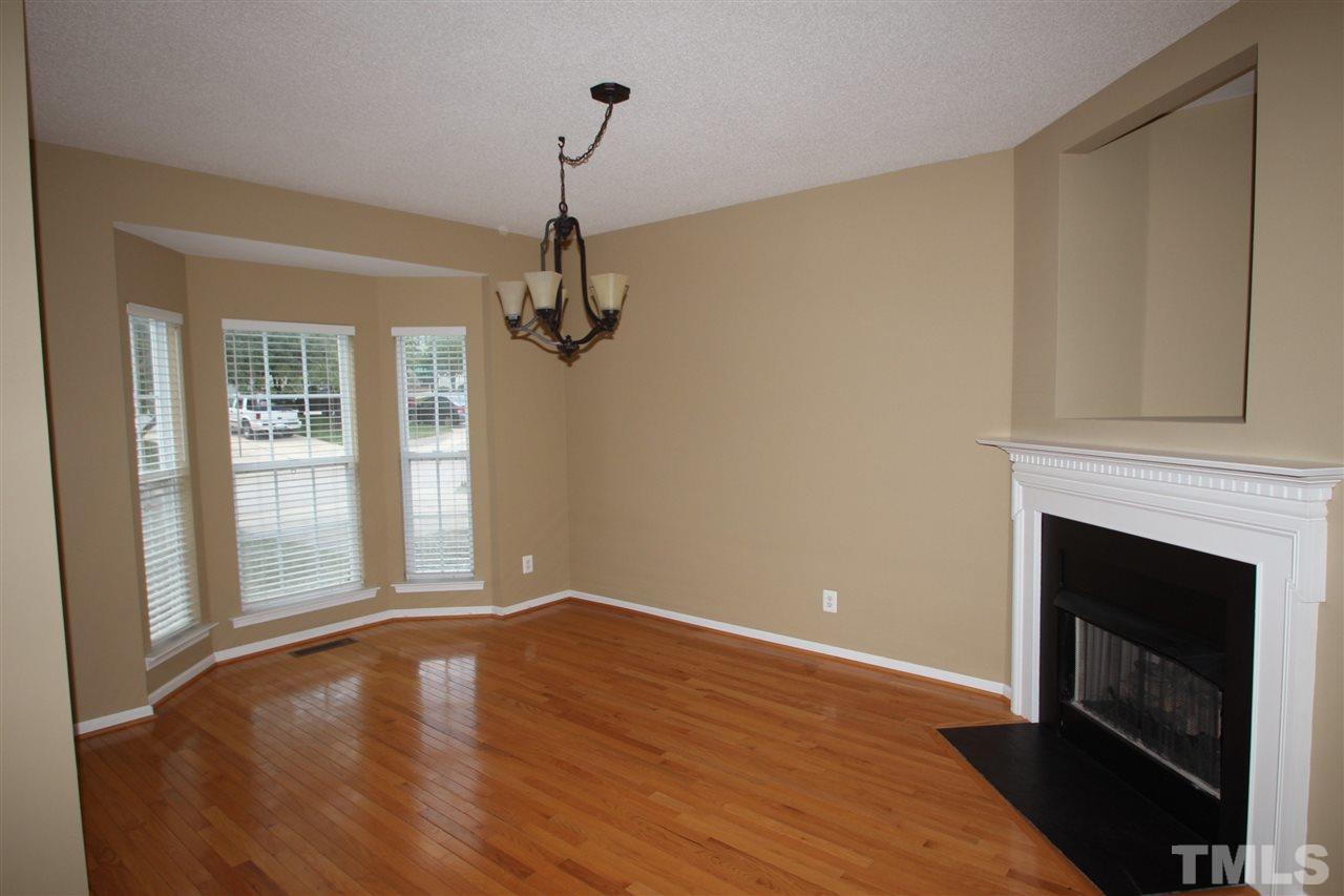 5312 Arete Way Raleigh, NC 27607 - Photo 2 of 20 a view of empty room with wooden floor and fireplace