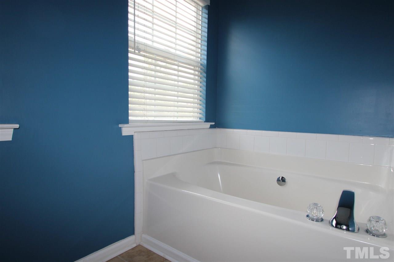 5312 Arete Way Raleigh, NC 27607 - Photo 13 of 20 a white bath tub sitting in a bathroom