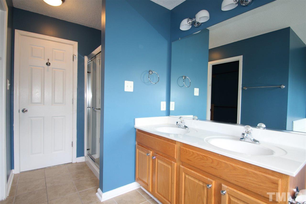 5312 Arete Way Raleigh, NC 27607 - Photo 14 of 20 a bathroom with a sink vanity granite shower and a mirror