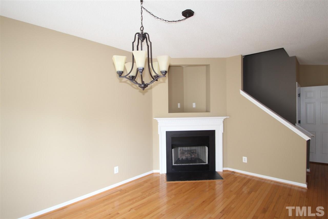 5312 Arete Way Raleigh, NC 27607 - Photo 3 of 20 a view of a livingroom with a fireplace and wooden floor