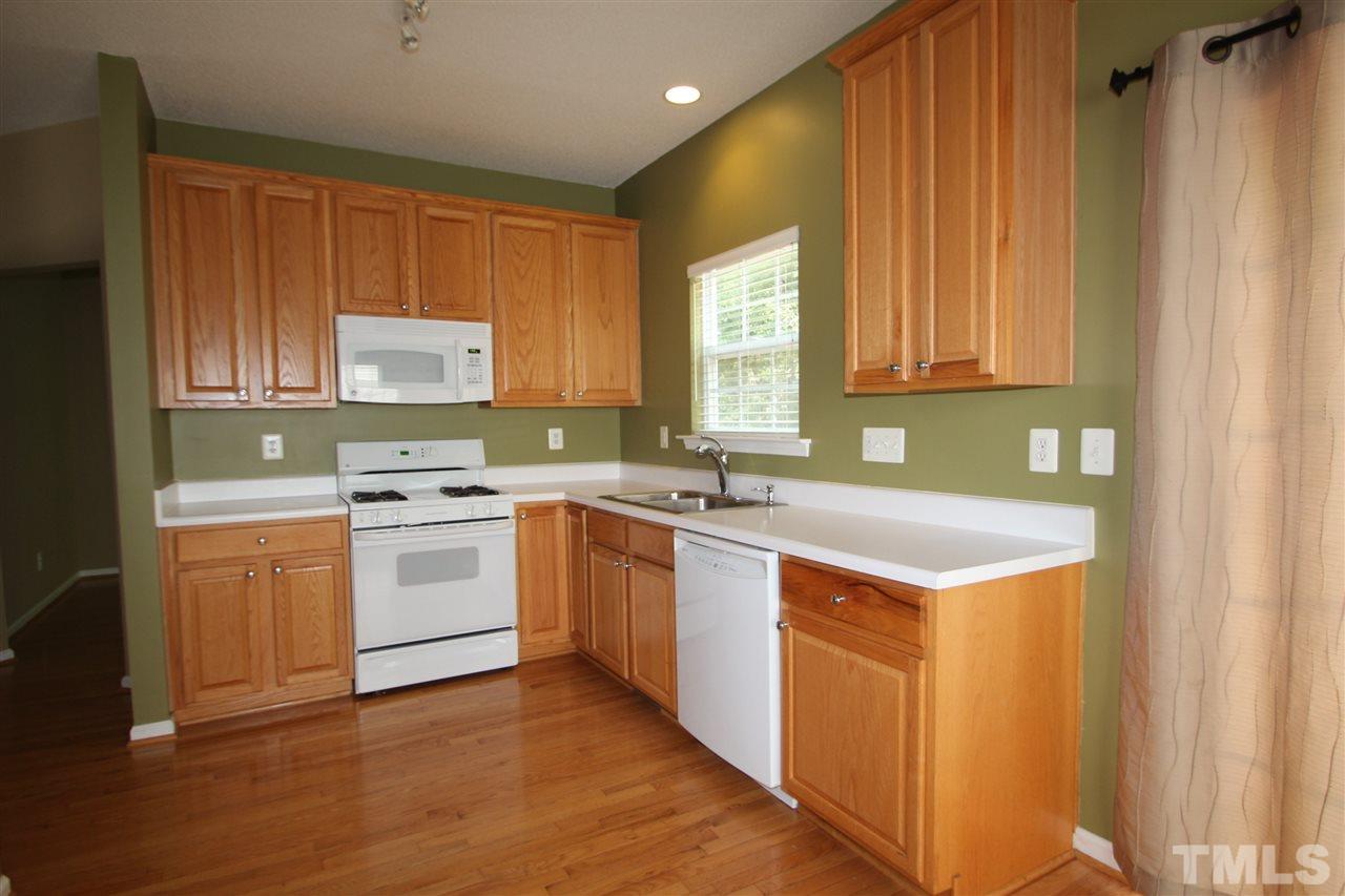 5312 Arete Way Raleigh, NC 27607 - Photo 4 of 20 a kitchen with stainless steel appliances granite countertop a stove a sink and a microwave