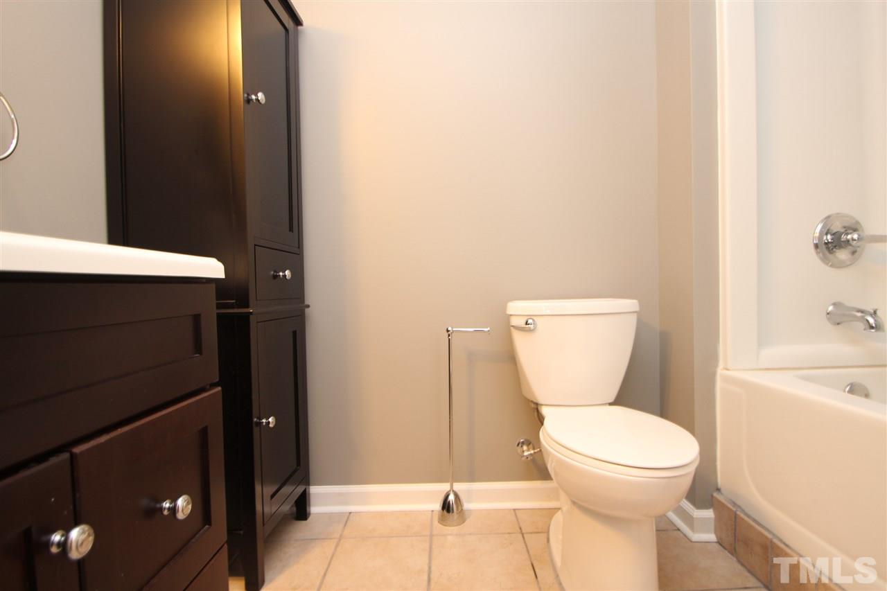 5312 Arete Way Raleigh, NC 27607 - Photo 9 of 20 a bathroom with a toilet a sink and mirror