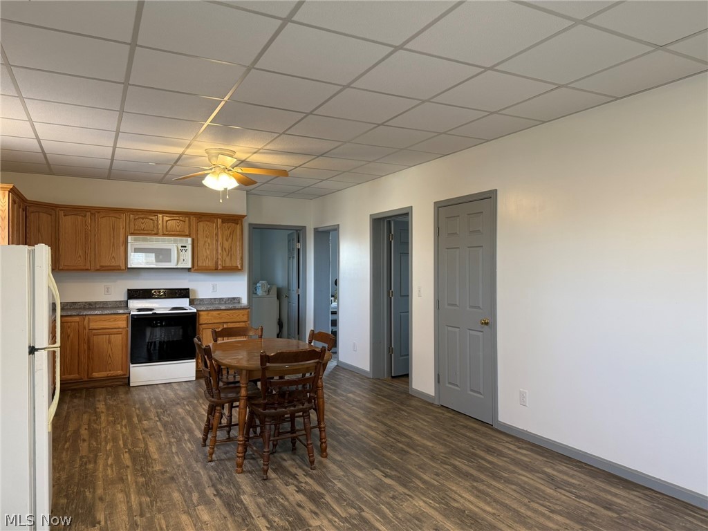 23033 Cadiz Road Freeport, OH 43973 - Photo 6 of 31 Dining room with ceiling fan, dark wood-style flooring, a paneled ceiling, and washer / dryer
