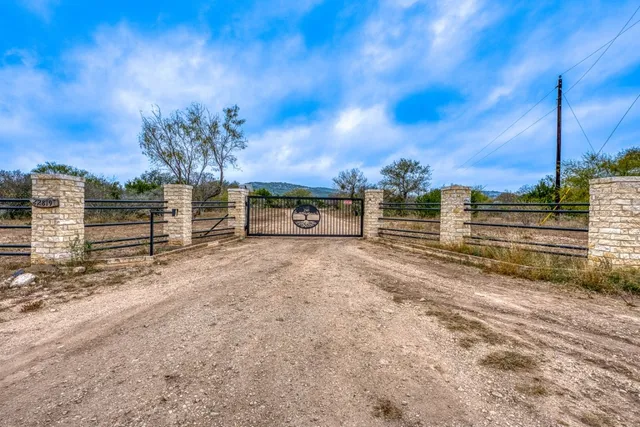 a view of a yard with wooden fence