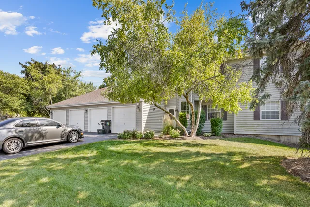 a view of a house with backyard and a tree