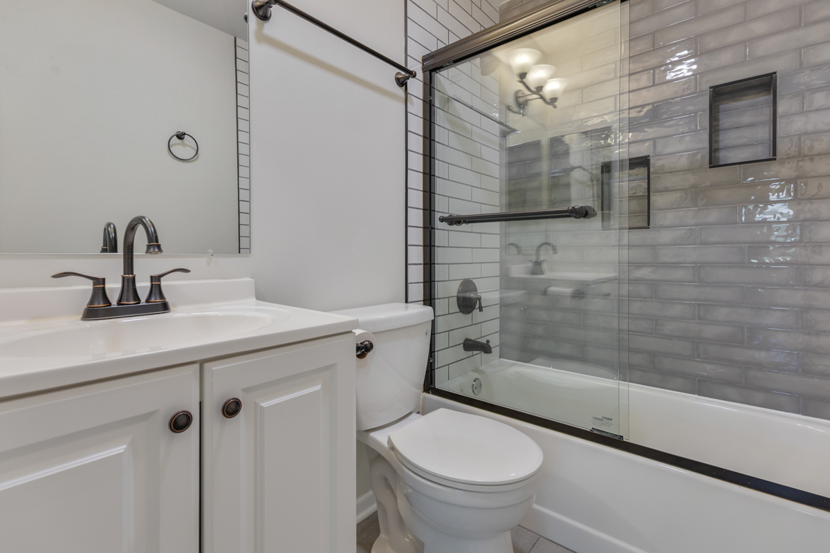 47 Gant Circle, Unit E Streamwood, IL 60107 - Photo 11 of 21 a bathroom with a sink a toilet and shower