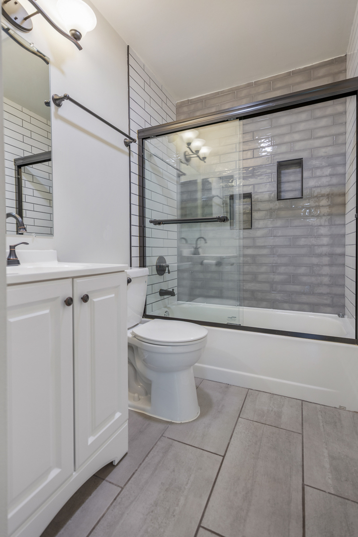 47 Gant Circle, Unit E Streamwood, IL 60107 - Photo 12 of 21 a bathroom with a toilet a sink and shower