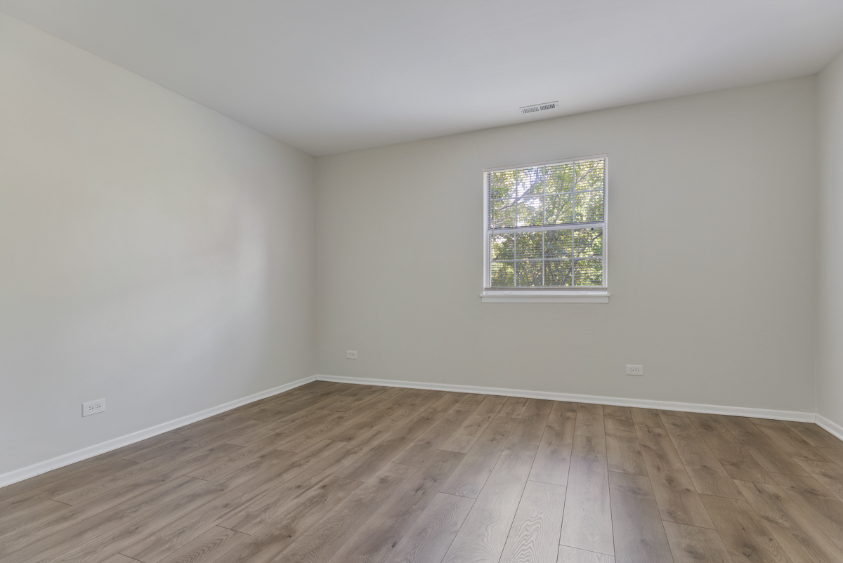 47 Gant Circle, Unit E Streamwood, IL 60107 - Photo 14 of 21 wooden floor in an empty room with a window