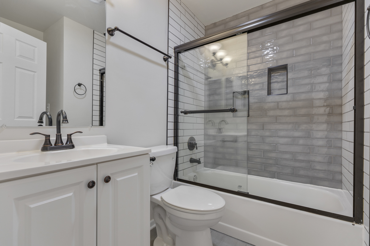 47 Gant Circle, Unit E Streamwood, IL 60107 - Photo 15 of 21 a bathroom with a sink a toilet and shower
