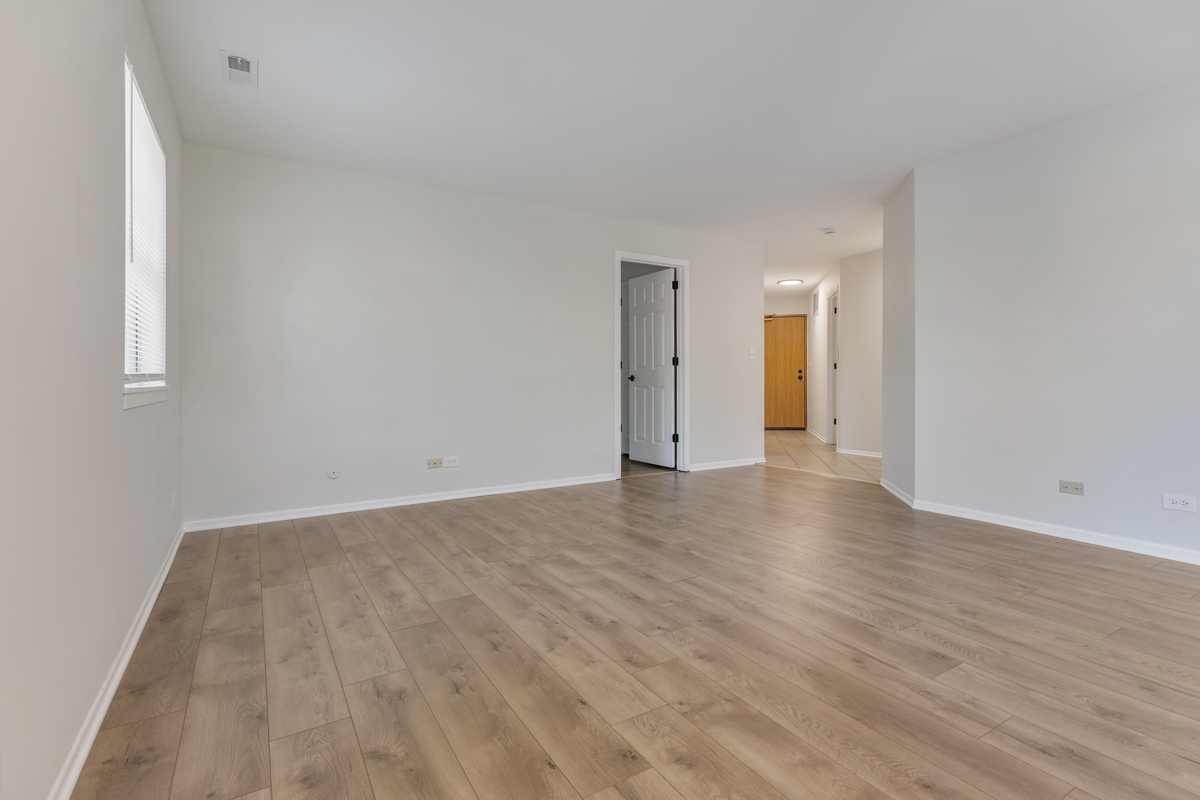 47 Gant Circle, Unit E Streamwood, IL 60107 - Photo 2 of 21 a view of an empty room and wooden floor