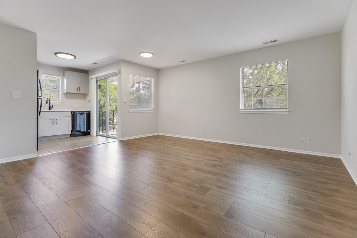47 Gant Circle, Unit E Streamwood, IL 60107 - Photo 3 of 21 an empty room with wooden floor and windows