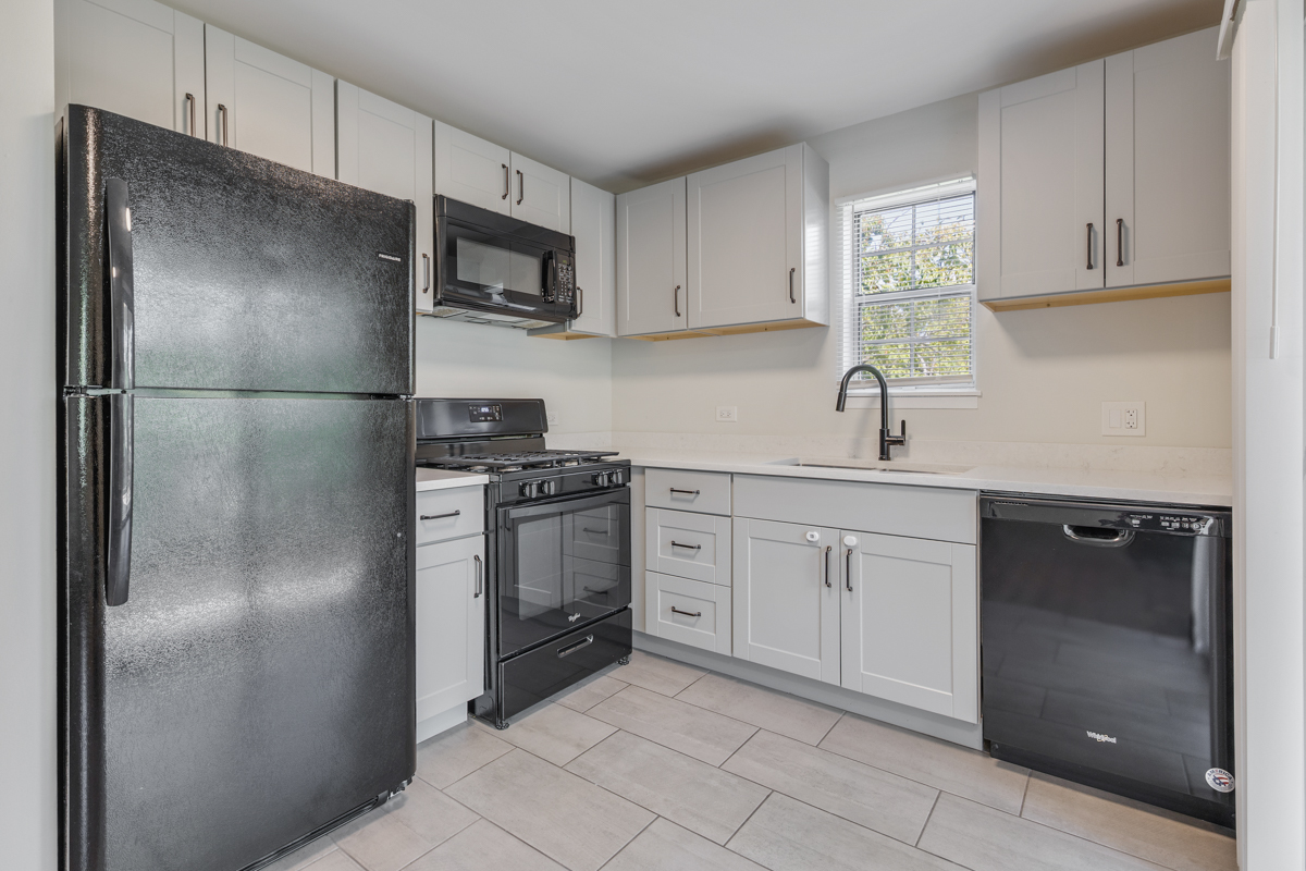 47 Gant Circle, Unit E Streamwood, IL 60107 - Photo 5 of 21 a kitchen with a refrigerator sink and cabinets