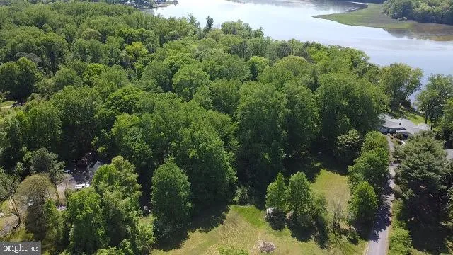 an aerial view of a house with yard