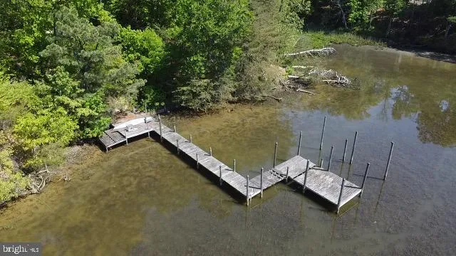 an aerial view of a house with a yard wooden table and chairs