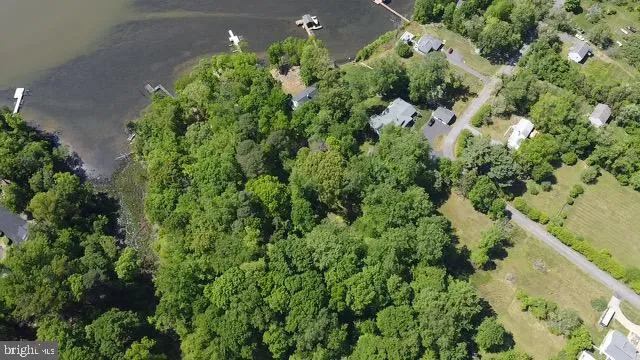an aerial view of a house with a yard and covered with swimming pool