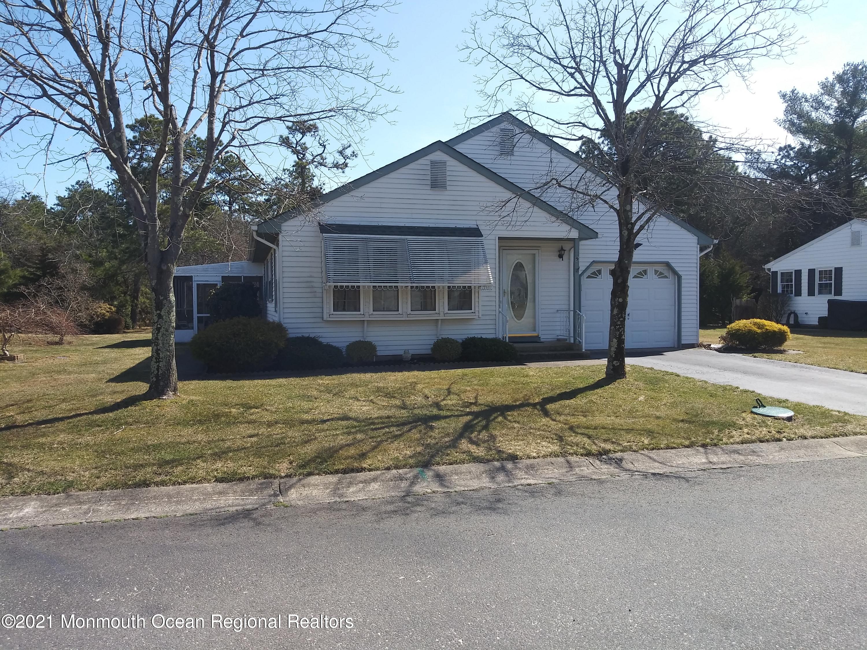 9 Ashley Road, Unit 63 Whiting, NJ 08759 - Photo 1 of 11 a house that has a large tree in front of it
