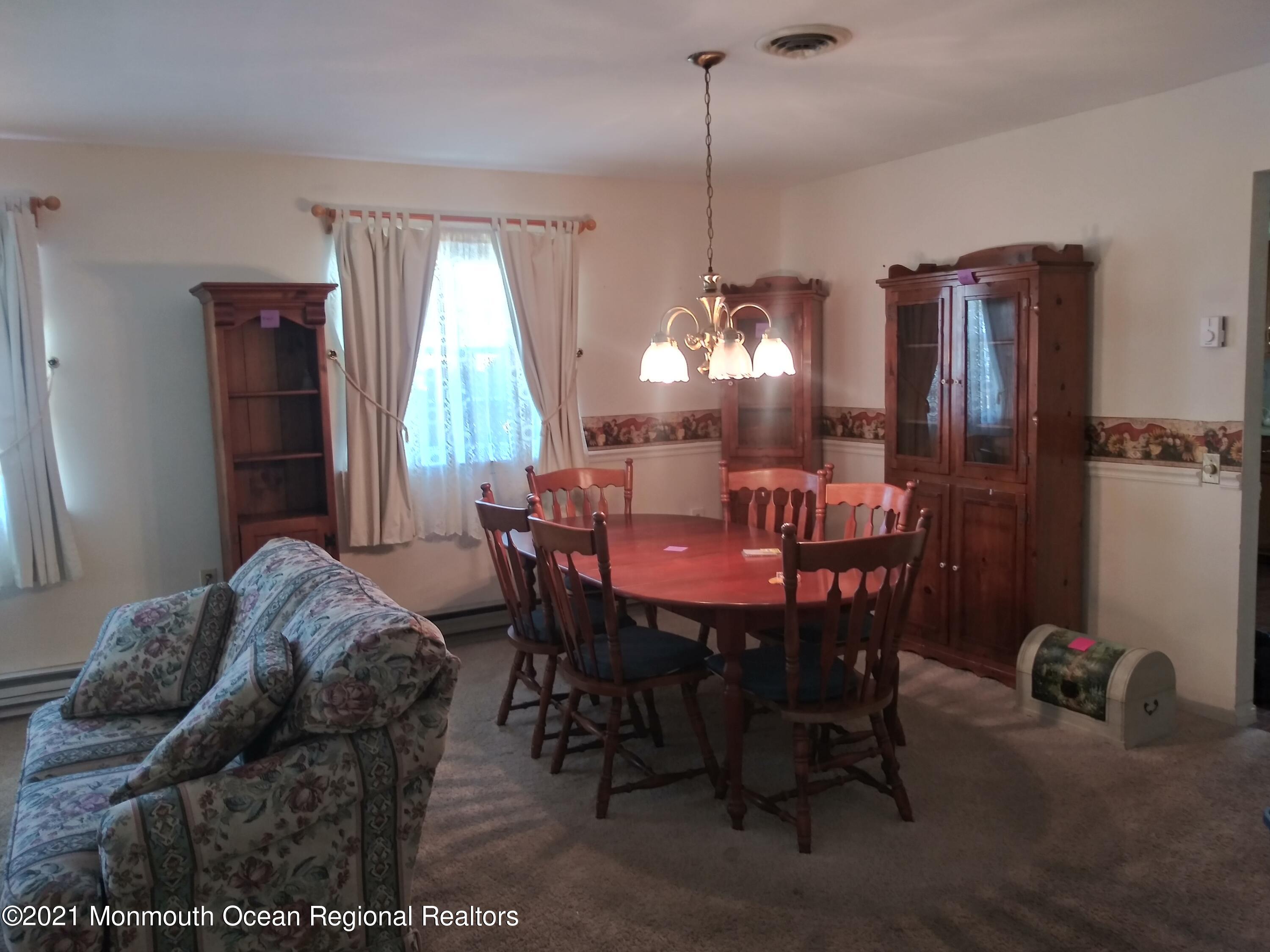 9 Ashley Road, Unit 63 Whiting, NJ 08759 - Photo 7 of 11 a view of a dining room with furniture window and outside view