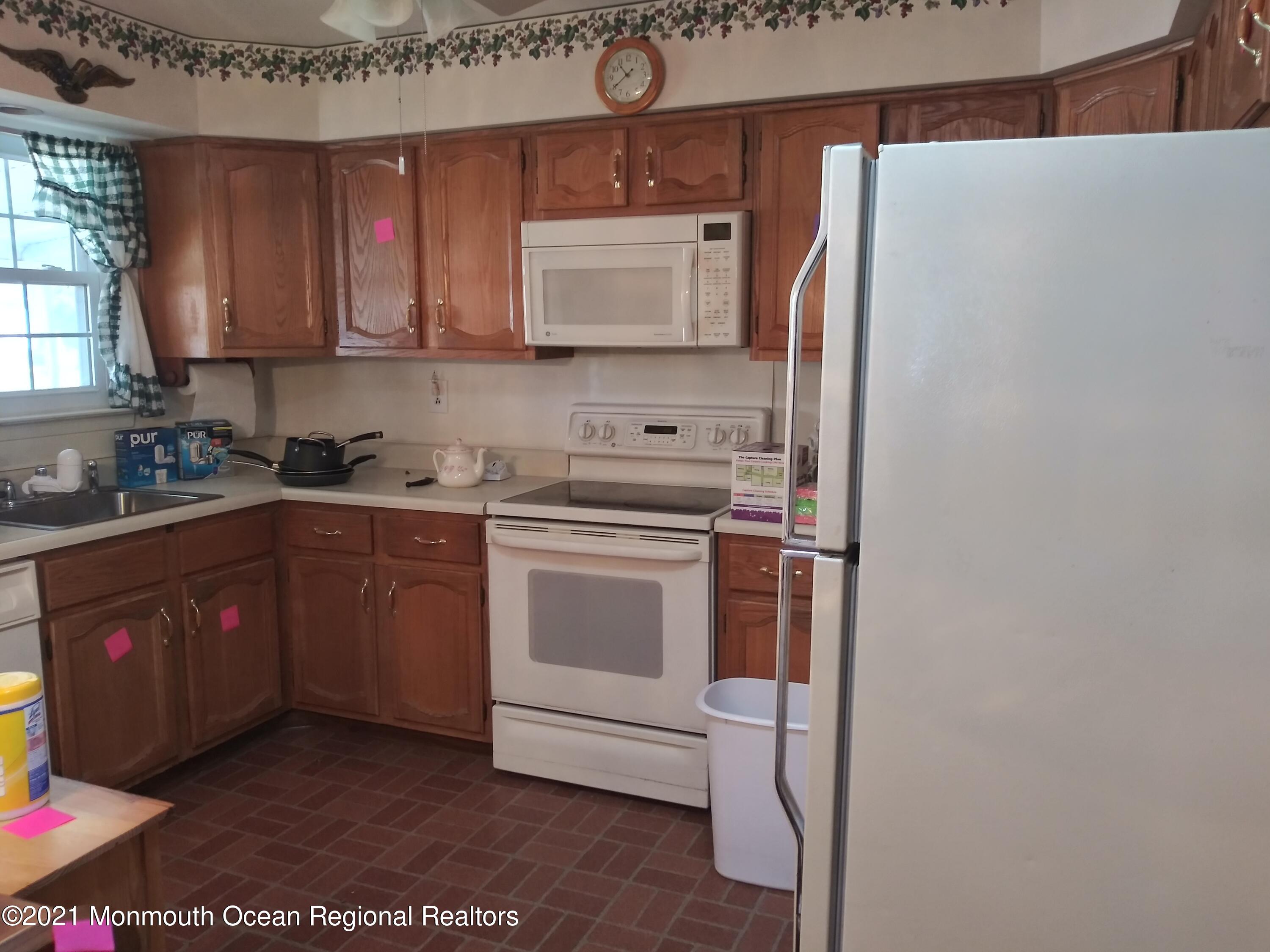 9 Ashley Road, Unit 63 Whiting, NJ 08759 - Photo 8 of 11 a kitchen with stainless steel appliances a refrigerator and a stove top oven