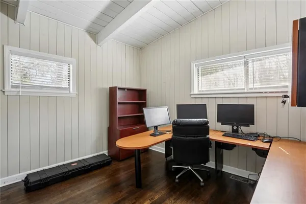 a view of a workspace with furniture and a window