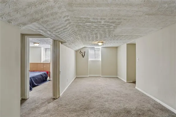 a view of a hallway with wooden shelves