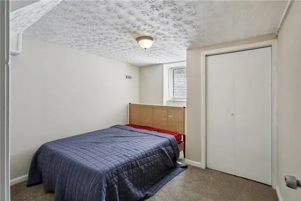 a bedroom with a bed and a potted plant