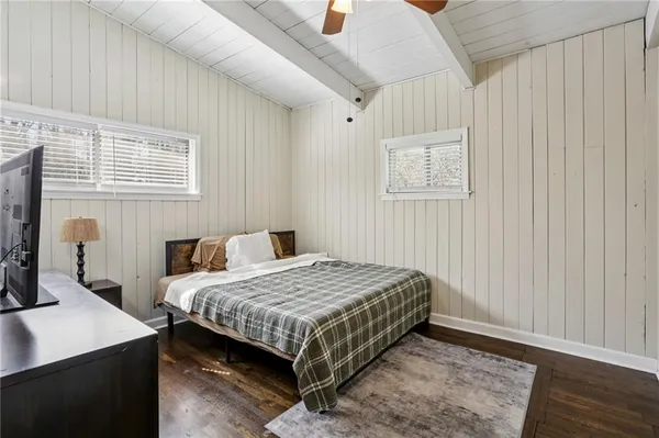 a bedroom with bed and a window