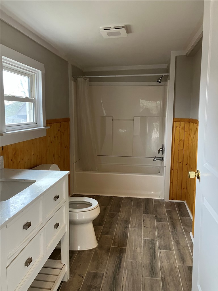 3 Wardlaw Street Pelzer, SC 29669 - Photo 3 of 6 Newly remodeled bathroom features wood-look tile flooring and wainscoting.