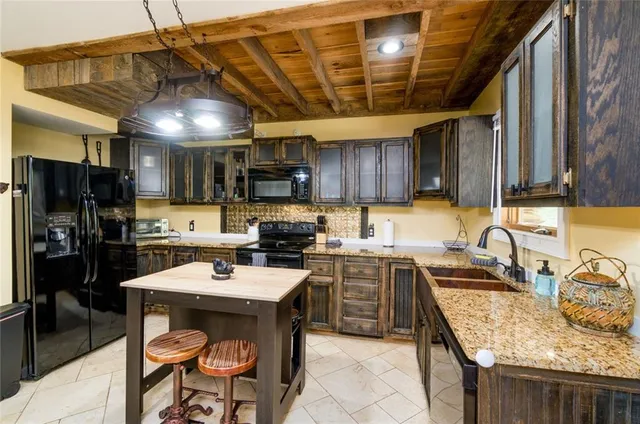 a kitchen with a sink a counter and chairs