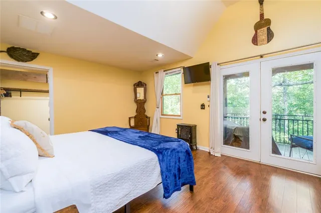 a bedroom with a bed and a large window