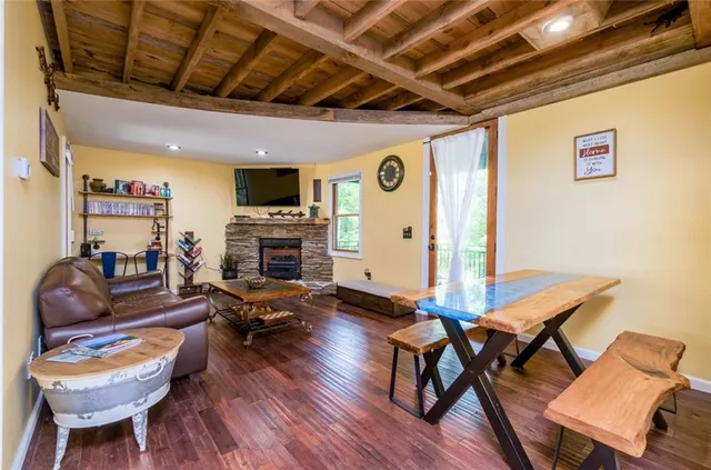 a living room with fireplace furniture and a wooden floor