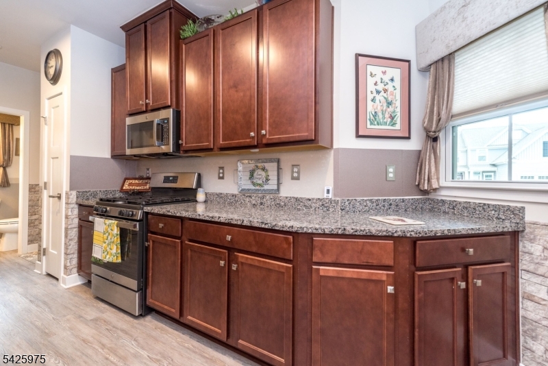 2 Sharp Shinned Court Washington, NJ 07882 - Photo 11 of 27 a kitchen with granite countertop wooden cabinets a sink and dishwasher