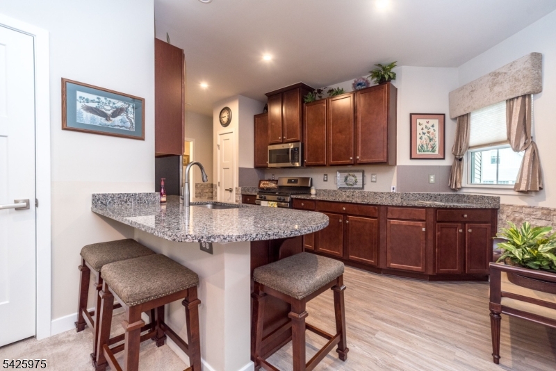 2 Sharp Shinned Court Washington, NJ 07882 - Photo 12 of 27 a kitchen with a sink cabinets and wooden floor