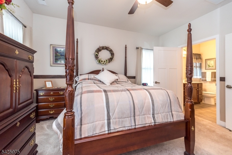 2 Sharp Shinned Court Washington, NJ 07882 - Photo 18 of 27 a bedroom with a bed and a chandelier