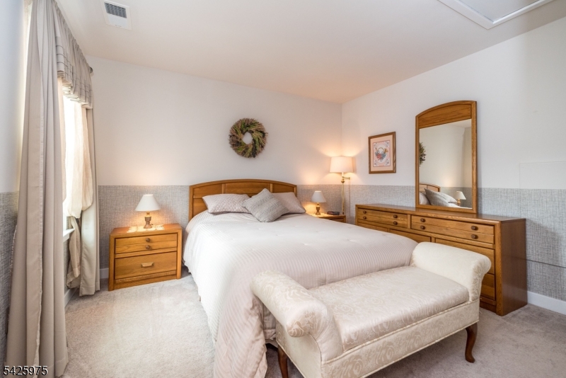 2 Sharp Shinned Court Washington, NJ 07882 - Photo 23 of 27 a bedroom with a bed and a couch