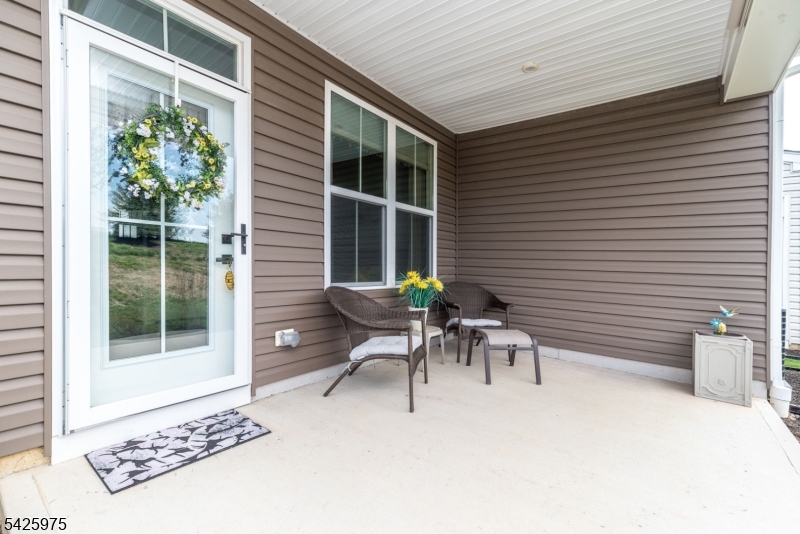 2 Sharp Shinned Court Washington, NJ 07882 - Photo 4 of 27 a view of a patio with table and chairs and potted plants