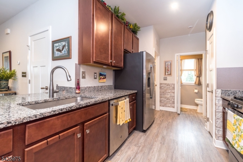 2 Sharp Shinned Court Washington, NJ 07882 - Photo 6 of 27 a kitchen with granite countertop a refrigerator stove and sink