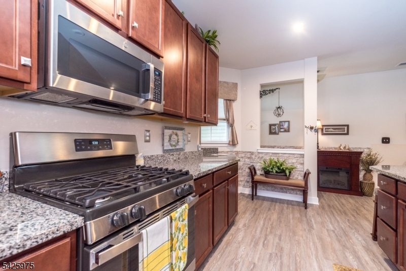 2 Sharp Shinned Court Washington, NJ 07882 - Photo 7 of 27 a kitchen with a stove and a microwave