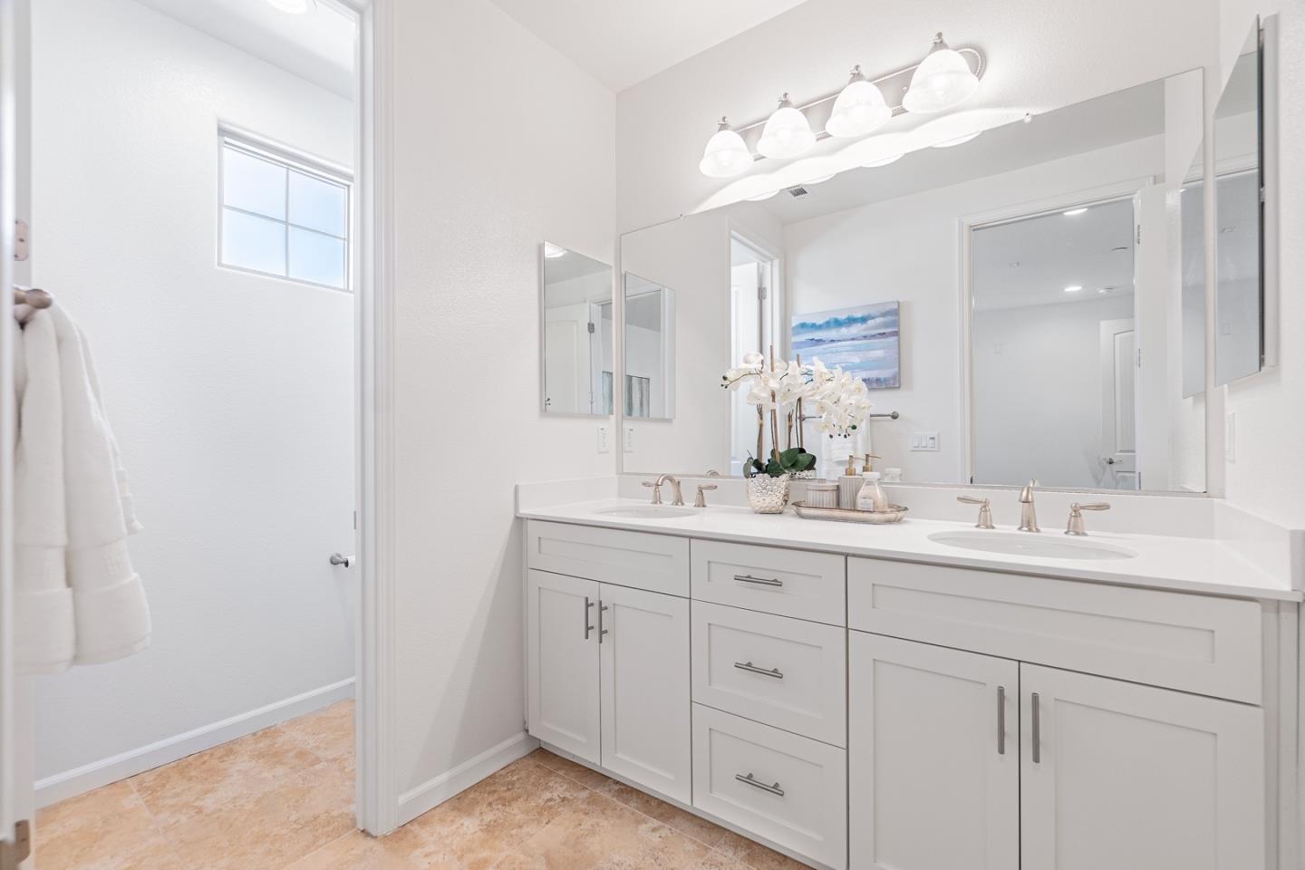 1926 Trento Loop Milpitas, CA 95035 - Photo 22 of 43 a bathroom with a double vanity sink and a mirror