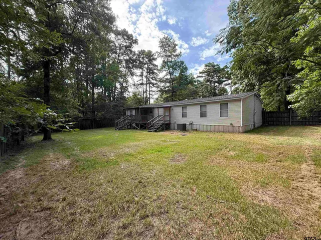 a view of a house with yard and sitting area