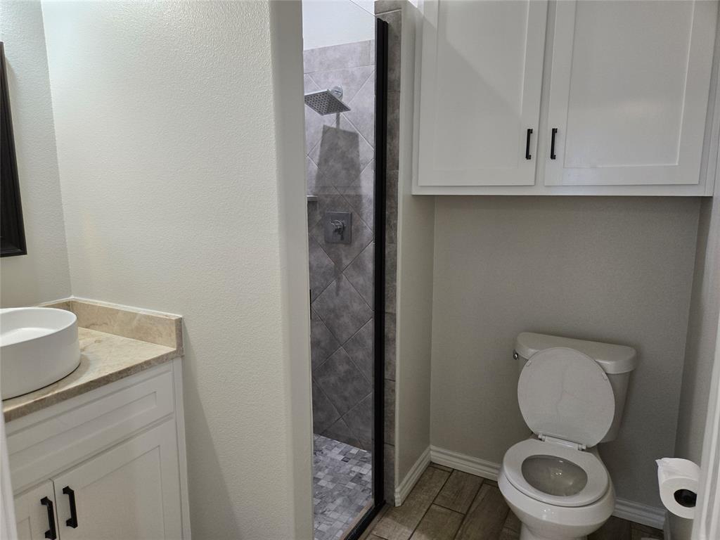 3704 Canyon Road Granbury, TX 76049 - Photo 16 of 30 a white toilet sitting next to a bathroom sink