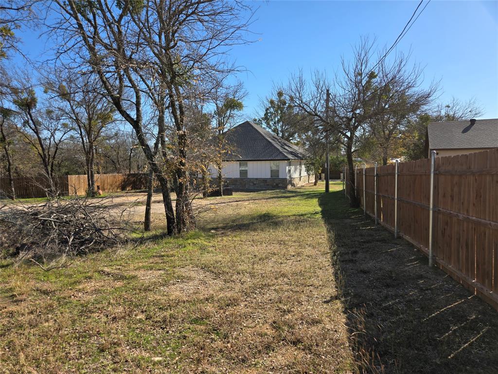 3704 Canyon Road Granbury, TX 76049 - Photo 29 of 30 a view of a yard with a house in the background
