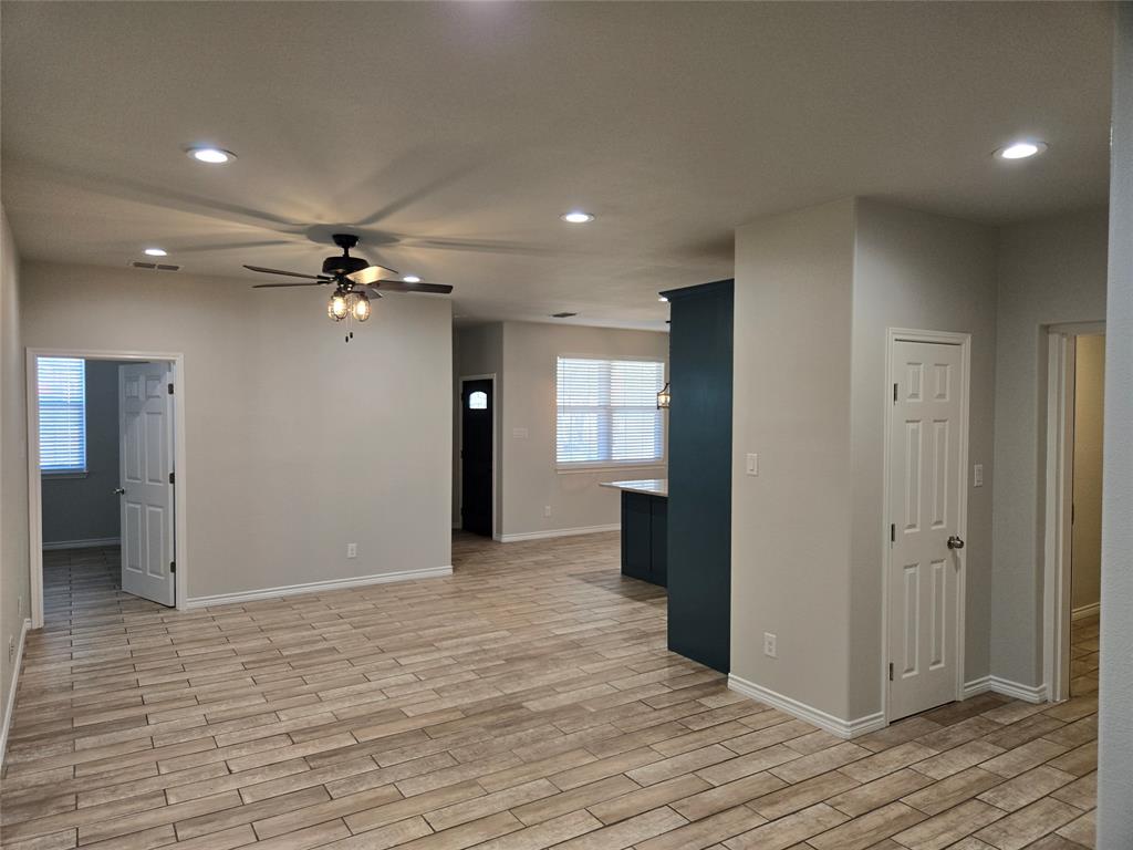 3704 Canyon Road Granbury, TX 76049 - Photo 3 of 30 a view of a room with a ceiling fan hardwood floor and hallway