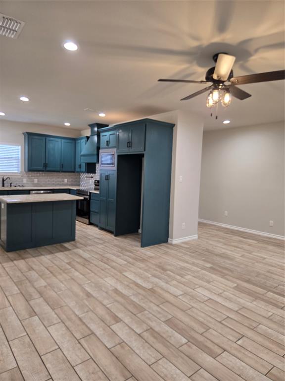 3704 Canyon Road Granbury, TX 76049 - Photo 5 of 30 a kitchen with stainless steel appliances kitchen island granite countertop a refrigerator and a sink