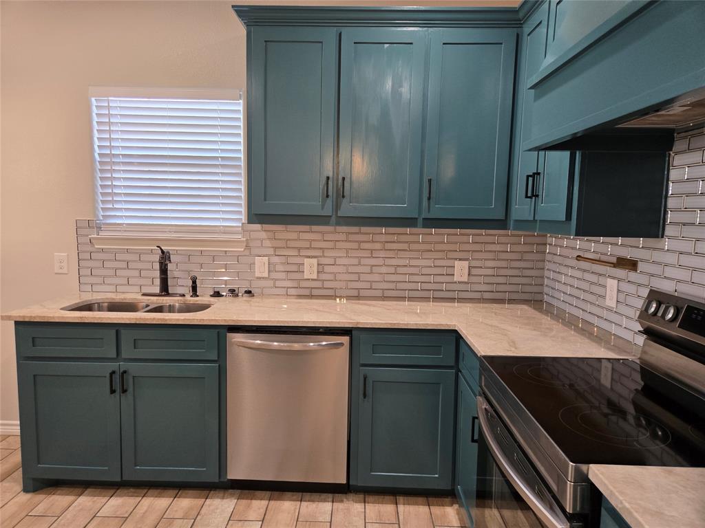 3704 Canyon Road Granbury, TX 76049 - Photo 7 of 30 a kitchen with a sink stove and cabinets